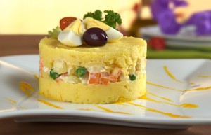 Causa Limeña Bites 
Layers of smooth potato terrine with avocado and chicken salad, served in spoon-sized portions.