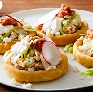 Mini Sopes with Refried Beans and Fresh Cheese
Thick corn masa cakes topped with beans, shredded meat, lettuce, and salsa.