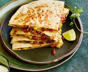 Quesadillas 
 Grilled tortillas filled with a melty blend of Oaxacan and Monterey Jack cheeses, marrying rustic charm with modern simplicity.