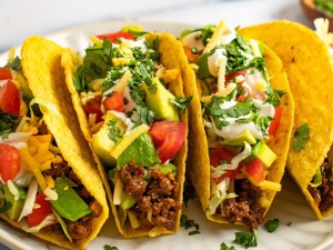 Tacos 
 Soft corn tortillas embracing tender, marinated meat topped with diced onions and cilantro, brightened by a hint of lime.
